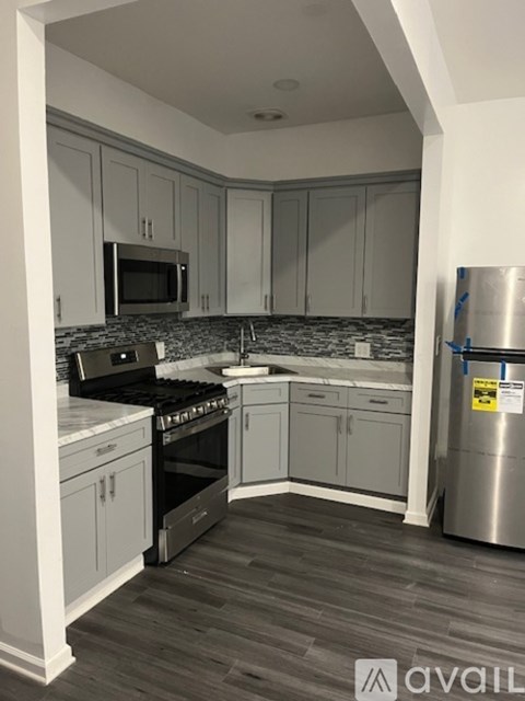 A kitchen with a stove top oven and a microwave.