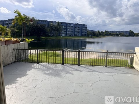 A balcony with a view of a lake and buildings.