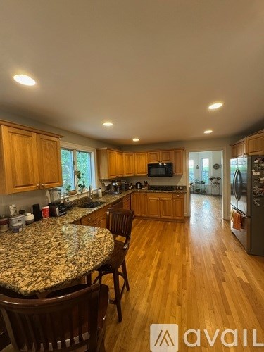 A kitchen with wooden cabinets and a granite countertop.