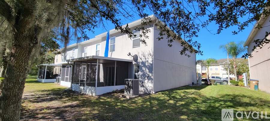 A white house with a blue stripe on the side is for sale.