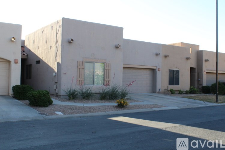 A row of houses with the first one having a window with bars on it.