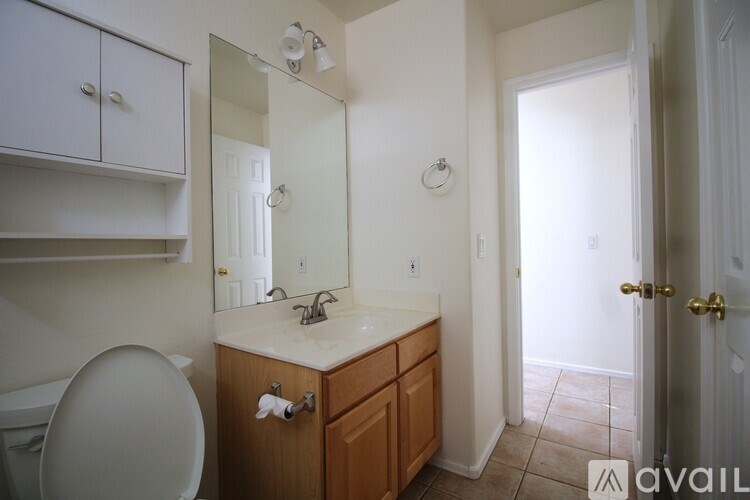 A bathroom with a toilet, sink, and bathtub.