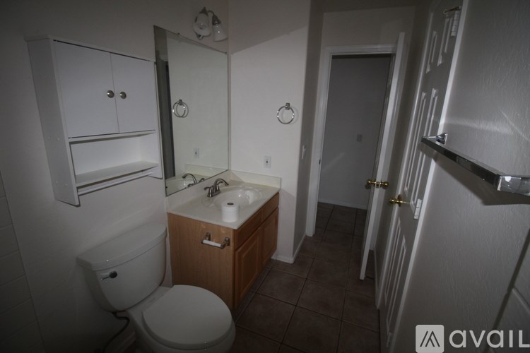A bathroom with a toilet, sink, and medicine cabinet.