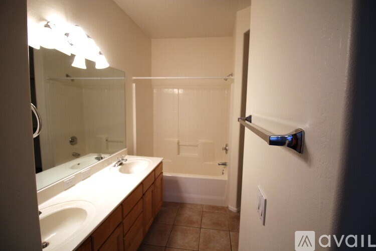 Empty walk-in closet with shelves and a wooden floor.