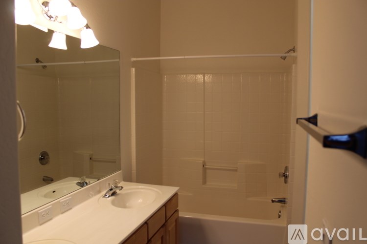 A bathroom with a white sink and a white bathtub.