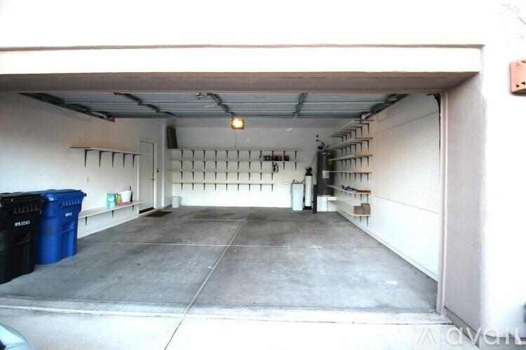 A white toilet in a small bathroom with a cabinet and a towel rack.