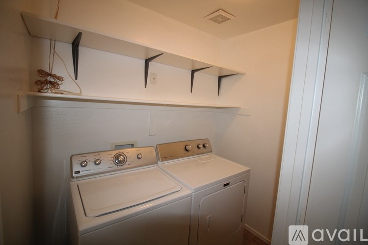 A white washer and dryer in a small laundry room.