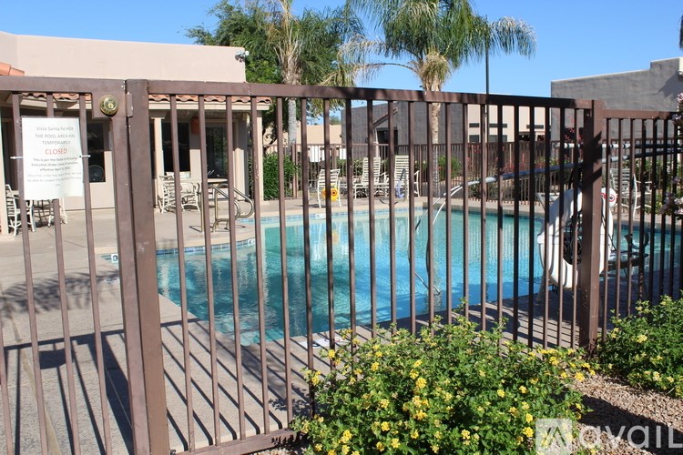 A pool surrounded by a fence with a sign that says closed.