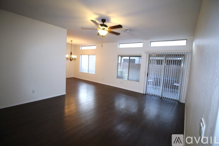 A tree in a yard with a blue sky in the background.