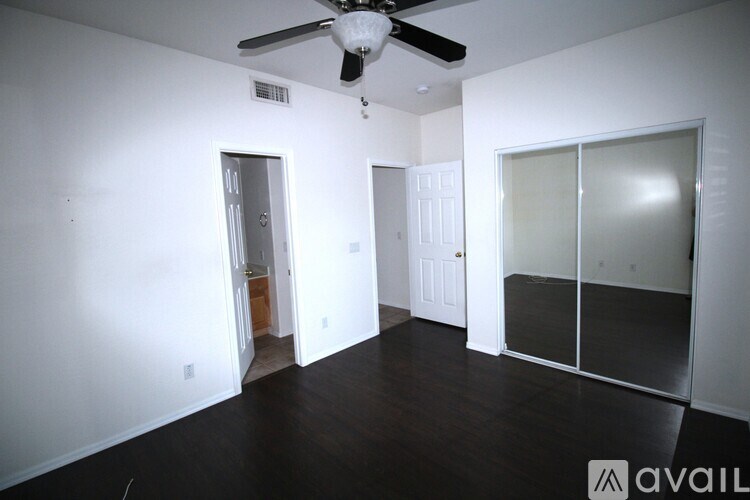 A kitchen with wooden cabinets and a black refrigerator.