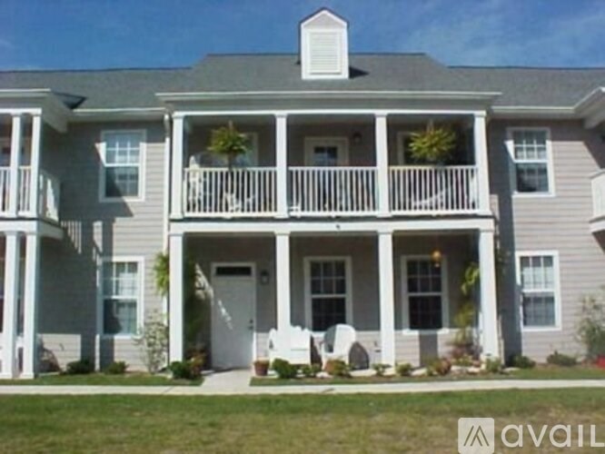 A house with a grey facade and a white door.