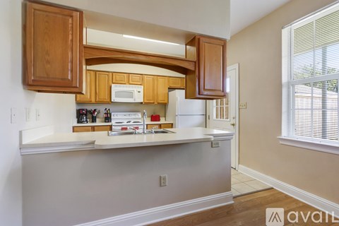A kitchen with wooden cabinets and a white refrigerator.