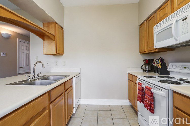 A kitchen with wooden cabinets and a white countertop.