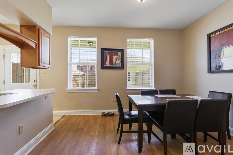 A dining room with a table and chairs.
