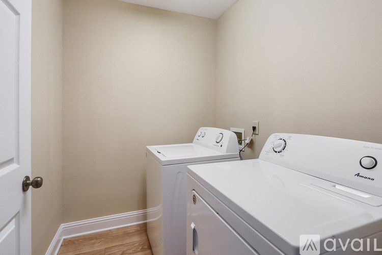 A white washing machine and dryer in a small laundry room.