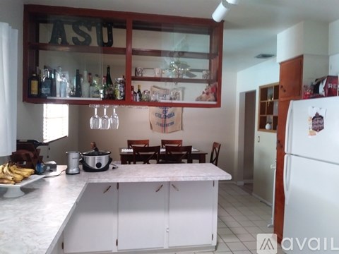 A kitchen with a white fridge and a white counter top.