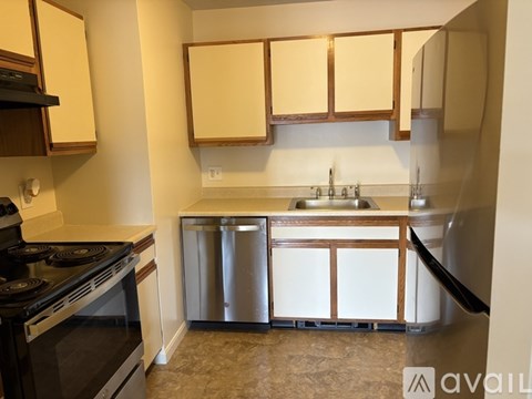 A kitchen with a black stove top oven and a black microwave above it.