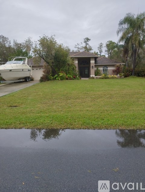 A house with a boat in front of it.