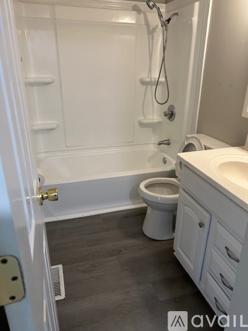 A bathroom with a toilet, sink, and shower.