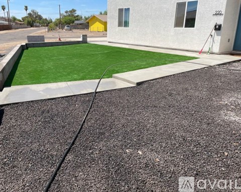 A house with a grey roof and a green lawn.