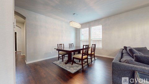 A living room with a dining table and chairs.