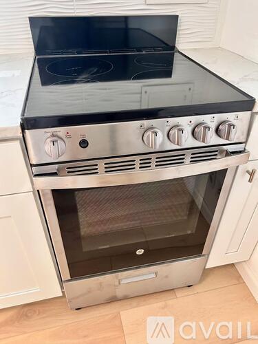 A stainless steel oven with a black top is installed in a kitchen.