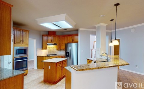 A kitchen with wooden cabinets and granite countertops.