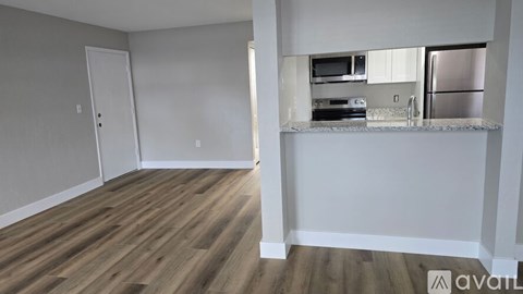 A kitchen area with a refrigerator, microwave, and oven.