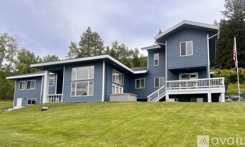 A blue house with a flag on the right side.