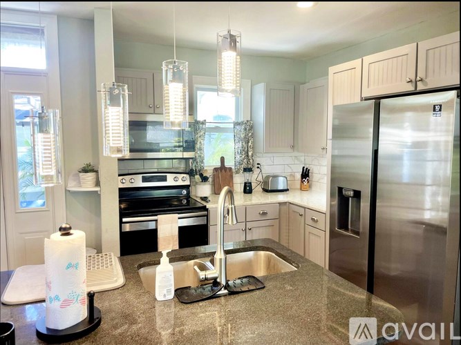 A kitchen with granite countertops and stainless steel appliances.