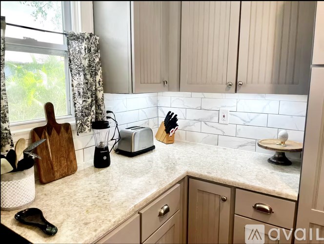 A kitchen counter with a cutting board, knife block, and a toaster.