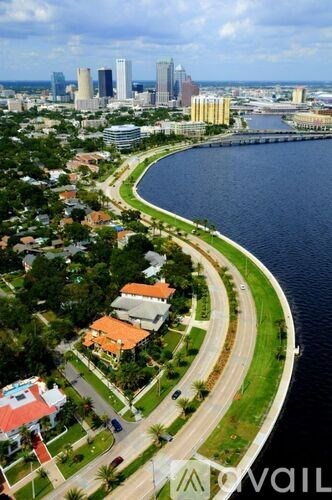 A cityscape with a curved road running through a residential area.