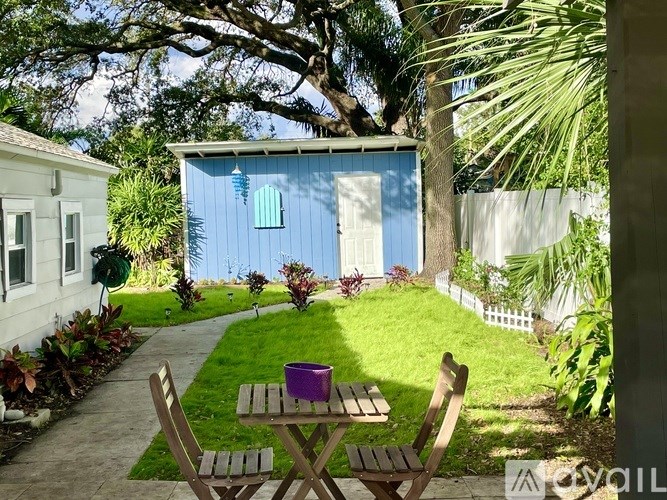 A residential area with a house, a tree, and a pathway.