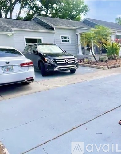 A black Mercedes-Benz SUV is parked on the side of a street.