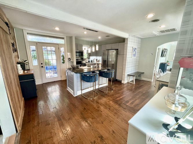 A kitchen with wooden floors and a large island.