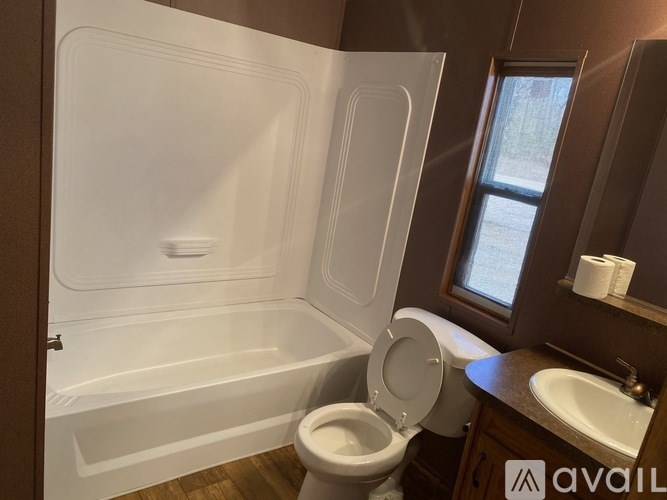 A bathroom with a toilet, sink, and bathtub.