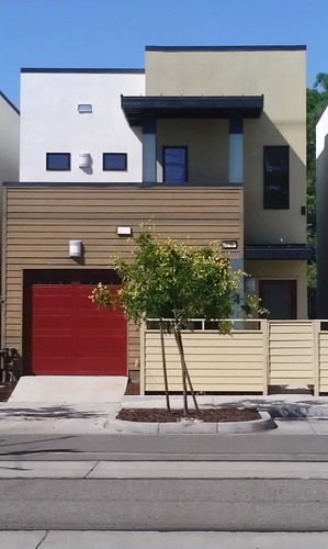 A modern house with a red garage door.