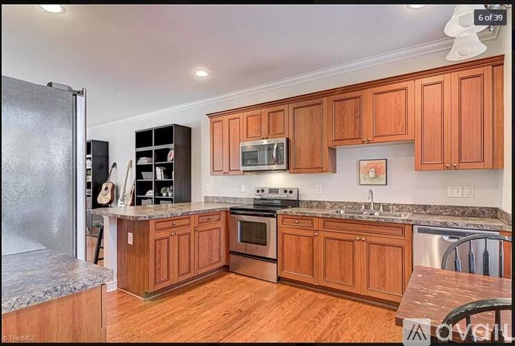 A kitchen with wooden cabinets and a granite countertop.