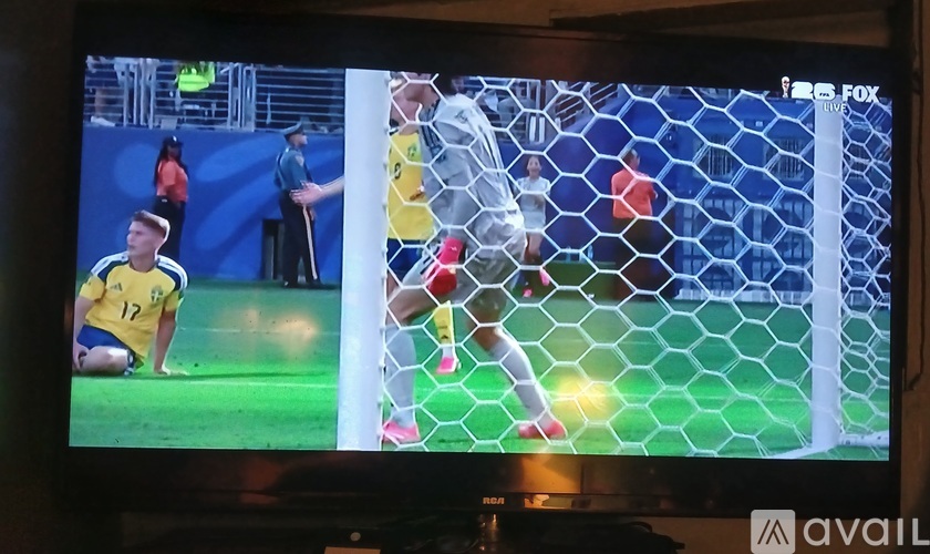 A soccer player in yellow is about to kick the ball.