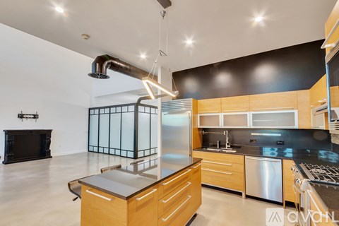 A modern kitchen with wooden cabinets and stainless steel appliances.