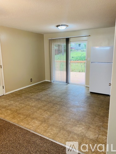 A room with a sliding glass door leading to a backyard.
