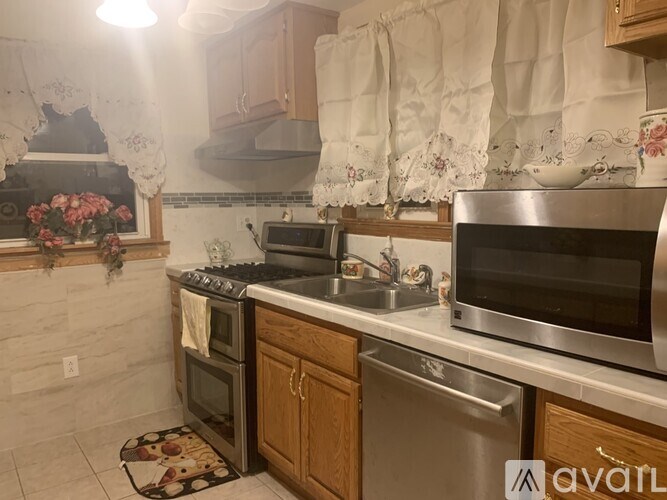 A kitchen with a stove, oven, and sink.