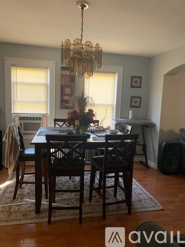 A dining room with a table set for a meal.