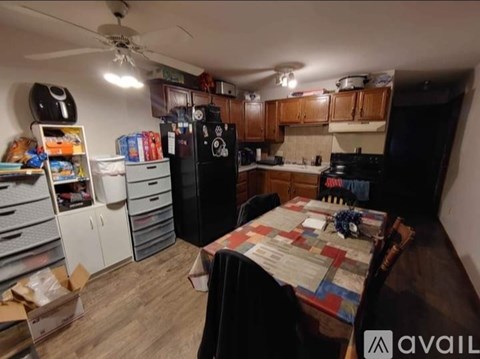 A kitchen with a table and chairs in the middle of the room.
