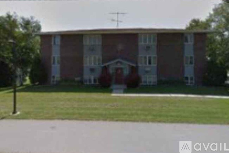 A large brick building with a white door and windows.
