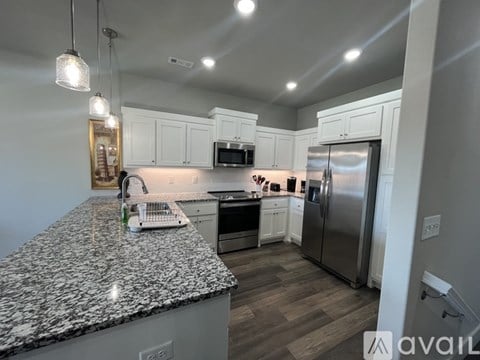 A kitchen with granite countertops and stainless steel appliances.