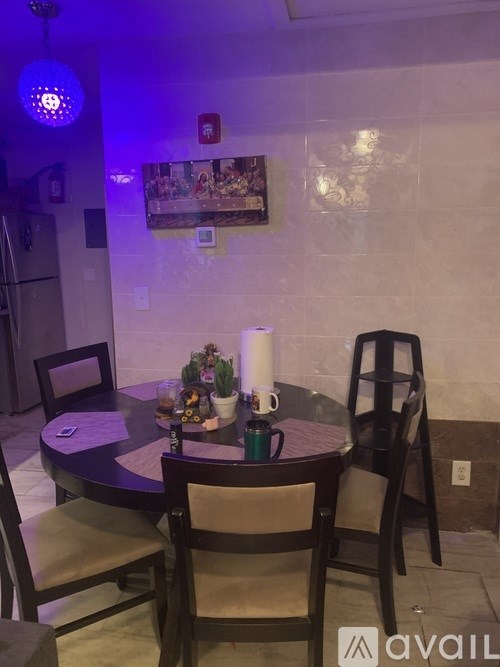 A dining table with chairs and a candle on it.