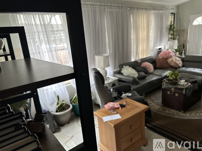 A living room with a grey couch and a wooden side table.
