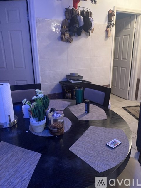 A black and white kitchen with a table and chairs.