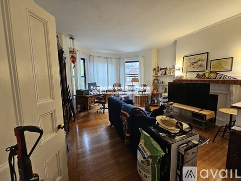 A living room with a couch and a fireplace.